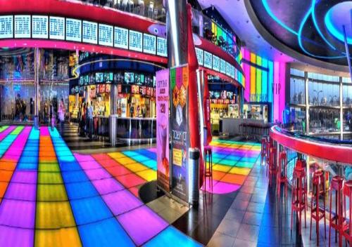 a brightly lit dance floor in a building at O&O Group - The SeaGate Estate suites - Suite 1 in Rishon LeẔiyyon
