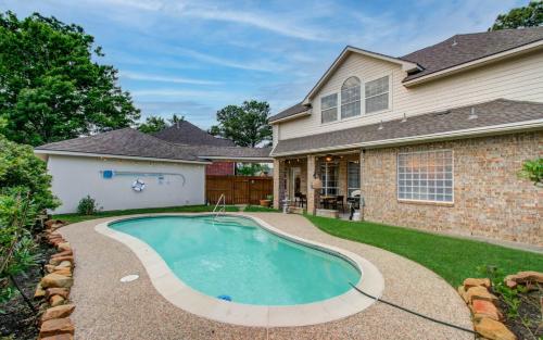 a house with a swimming pool in the yard at Big Texas Living - Spacious 5-BD with Pool in Cypress