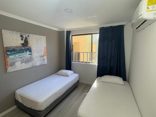 En eller flere senge i et værelse på Espectacular vista a la playa el Rodadero