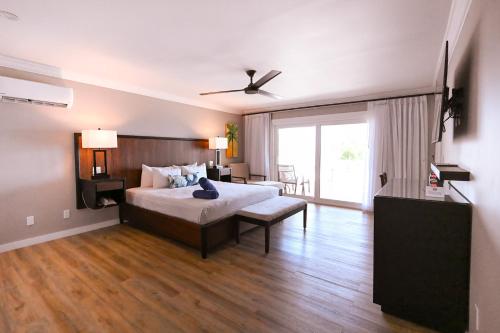a bedroom with a bed and a large window at St. James's Club Resort - All Inclusive in English Harbour Town