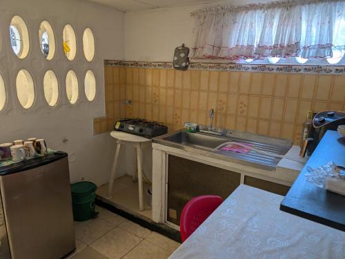 a kitchen with a sink and a stove and mirrors at English power Exotic point in Barranquilla