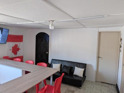 a room with a table and chairs and a couch at English power Exotic point in Barranquilla