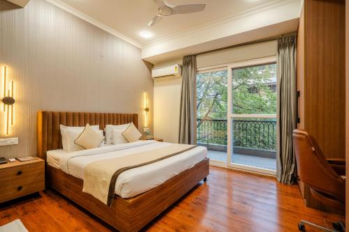 a bedroom with a bed and a large window at Royal Studio Golf Course Road in Gurgaon