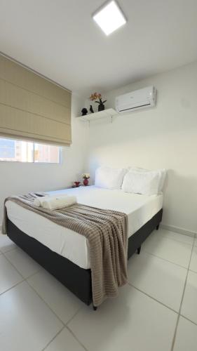a bedroom with a bed with a blanket on it at Refúgio de Luxo in Montes Claros