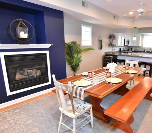 a dining room with a table and a fireplace at Tremont Whole House in Cleveland