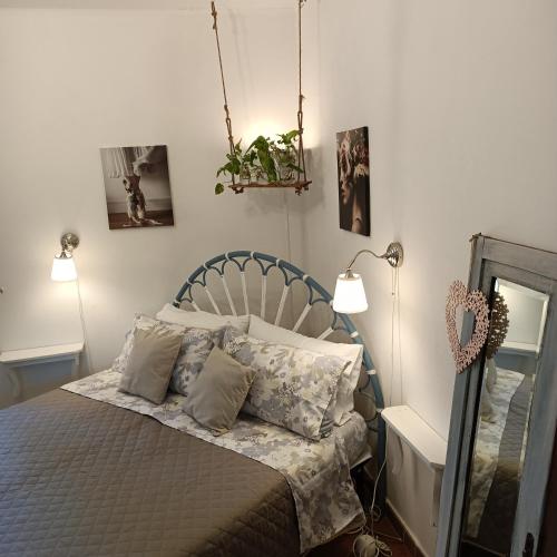a bedroom with a bed with two lamps and a mirror at Casale la Decima in Budrio
