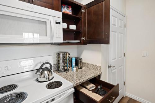 a kitchen with a stove and a microwave at Relaxing Place Close to Skiing in Midvale