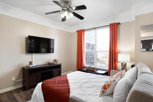 a bedroom with a bed and a flat screen tv at Relaxing Place Close to Skiing in Midvale