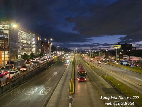 a city street filled with lots of traffic at night at Hotel Castellana 100 Bogota By Hoteles Confort 80 in Bogotá