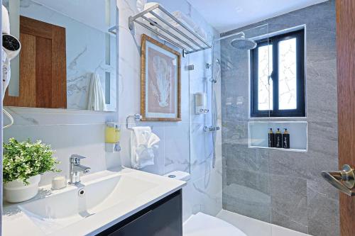 a bathroom with a sink and a shower at Elegant Cocotal 2BD Condo in Punta Cana