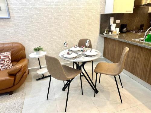 a table and chairs in a room with a kitchen at Lovely 1BR Apt, King Bed, Pool in La Julia