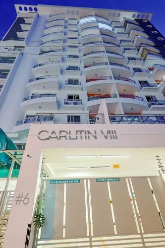 a large white building with the words caribbean vii at Lovely 1BR Apt, King Bed, Pool in La Julia
