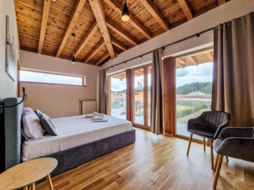 a bedroom with a bed and a table and chairs at Aquaterra Hot Spring Villa - Banya in Banya