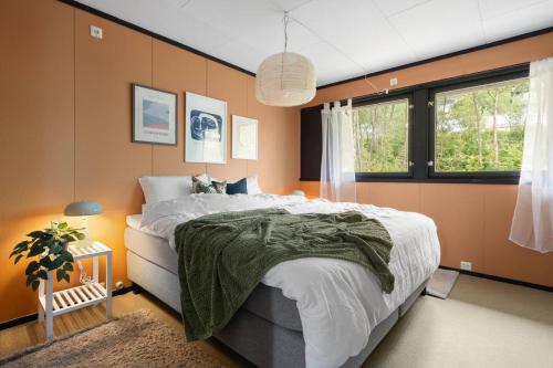 a bedroom with a large bed and a window at Tomasjord home, the top floor in Trondalen