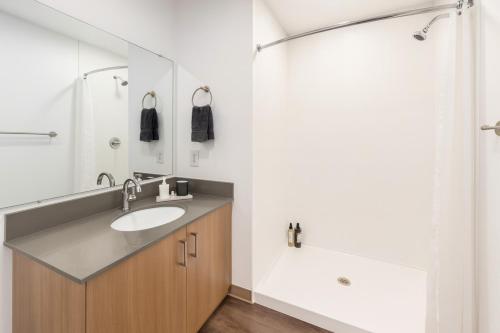 a bathroom with a sink and a shower at Five Points South Spacious 2BR with 2 Queens in Birmingham