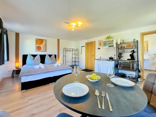a living room with a bed and a table with chairs at Apartment EverydayGood Erholung-Stadtnah-Anbindung-Einkauf-Biergarten in Salzweg