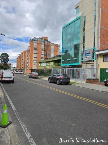 a street with cars parked on the side of the road at Hotel Castellana 100 Bogota By Hoteles Confort 80 in Bogotá
