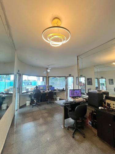 an office with a desk with a laptop computer on it at Status Elegance Hotel in Serra