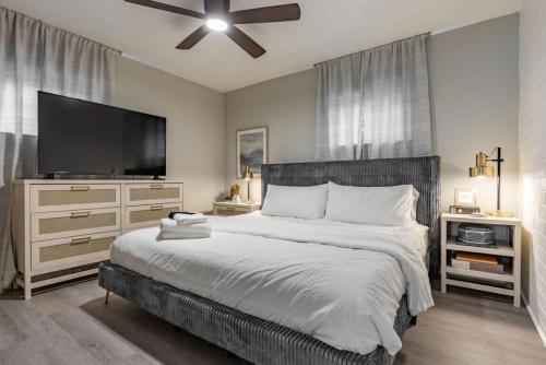 a bedroom with a large bed with a flat screen tv at Westlake Getaway Apartment in Westlake