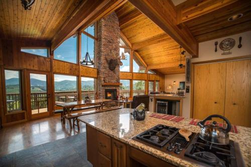 a kitchen with wooden ceilings and a view of a mountain at A-frame, Grand Views, Hot Tub, Mins To Boone & Asu in Sugar Grove