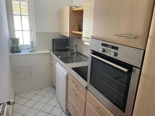 a kitchen with a sink and a stove at Apartment im Scheffelhaus in Gengenbach
