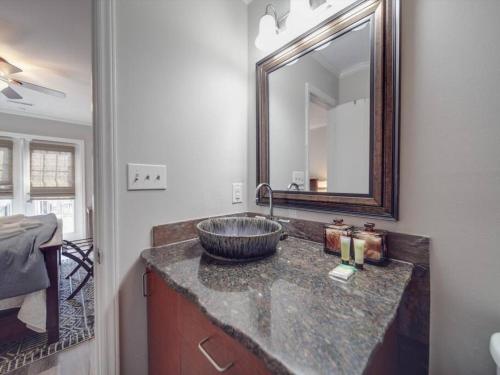a bathroom with a sink and a mirror on a counter at Cozy 3BR Bungalow - City Views - Firepit -Football in Charlotte