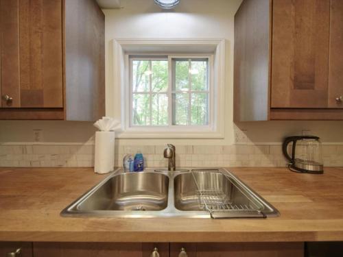 fregadero de acero inoxidable en una cocina con ventana en Warm Days and Cool Knights Fire Pit Boat Rental, en Mayhew