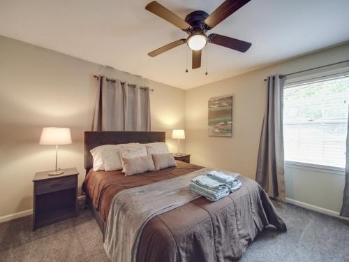 a bedroom with a bed with a ceiling fan at 4 BR South Charlotte Getaway Min to Everything in Charlotte