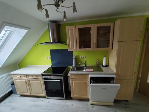 a kitchen with a sink and a stove top oven at Ferienwohnung Auerbergblick in Sangerhausen