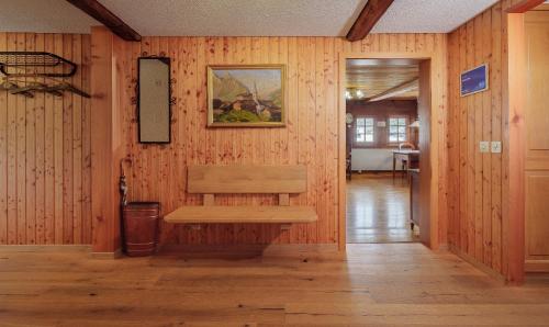 a wooden wall with a bench in a hallway at Cricerhaus in Visp