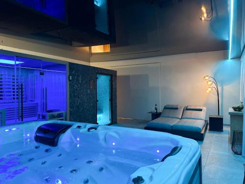 a large bathroom with a tub in a room at Domaine du Rondia - Chambres d'hôtes et Wellness in Wanze