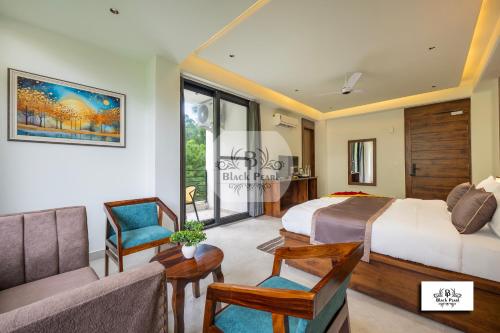 a hotel room with two beds and a couch at The BlackPearl Hillcrest in Kasauli