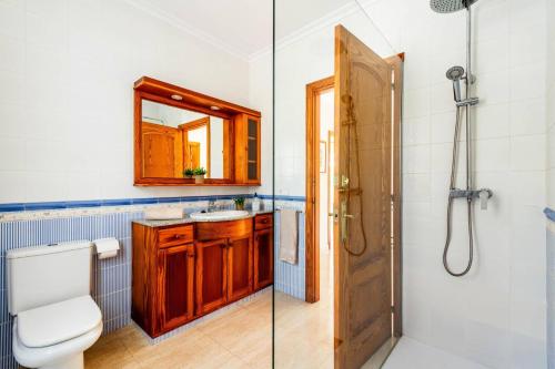 a bathroom with a toilet and a sink and a shower at Villa Manuel by Villa Plus in Son Parc