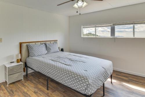 a white bedroom with a bed and a window at Mtn-View Coulter Escape w/ Rustic Tree Lookout in Coulterville