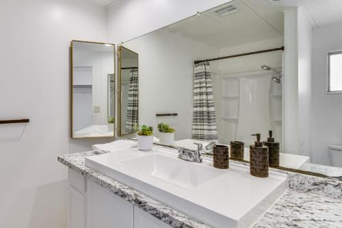 a white bathroom with a sink and a mirror at Mtn-View Coulter Escape w/ Rustic Tree Lookout in Coulterville