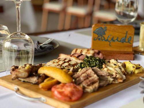 a plate of food with meat and vegetables on a table at Resort Açude 