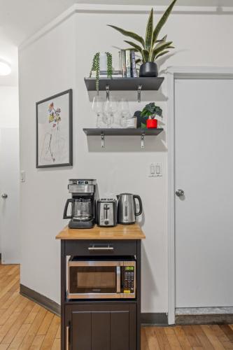 a kitchen with a counter with a microwave on it at Heart of Downtown Manhattan - Stylish One Bedroom Apartment in Vibrant Union Square in New York