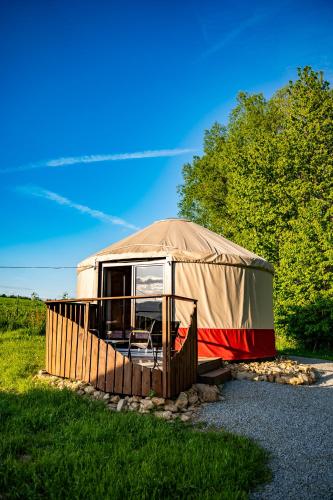 a yurt in a field with trees in the background at Jurty za winklem ze strefą SPA in Rudnica