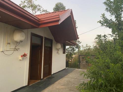 a building with an awning on the side of it at Daynish Rock Bungalow in Hatton