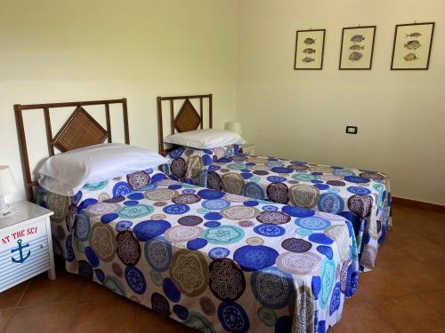 two beds sitting next to each other in a room at Villa Marina Grande in San Sostene Marina