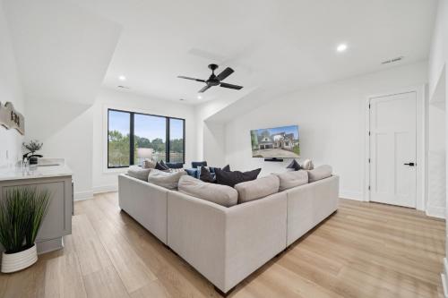a white living room with a large white couch at Luna's Lake Life in Terrell
