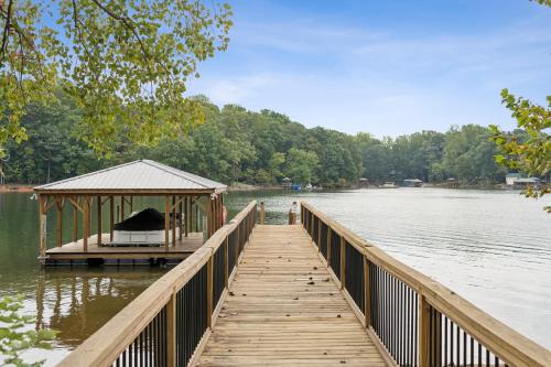 a wooden dock with a gazebo on a lake at Luna's Lake Life in Terrell