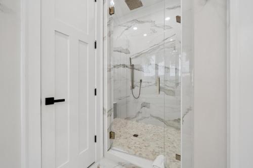 a bathroom with a shower with a glass door at Luna's Lake Life in Terrell