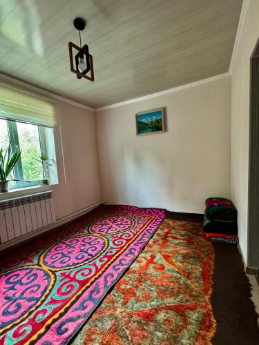 a room with a colorful rug on the floor at Nomad House in Yur'yevka