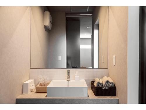 a bathroom with a white sink and a mirror at Kamogawa Sea Sauna Villa - Vacation STAY 45731v in Kawaguchi