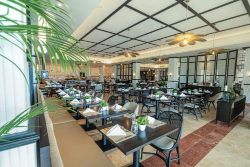 a restaurant with tables and chairs in a room at The Signature Level at Grand Palladium Lady Hamilton Resort & Spa- All Inclusive in Lucea