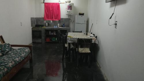 a wet room with a table and a refrigerator at Leo y Mar in Mar de Ajó