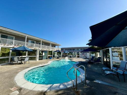 a swimming pool in front of a hotel at Monterey Bay Lodge in Monterey