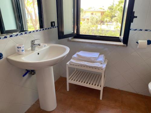 a bathroom with a sink and a window at Villa Marina Grande in San Sostene Marina