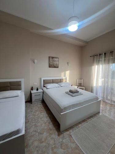 a bedroom with two beds and a blue light at Dyrrah G In the heart of Durres in Durrës